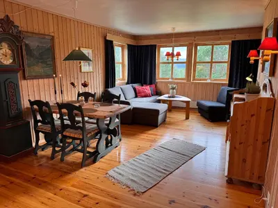a living room with a table and a couch at Høvringen Lodge in Høvringen