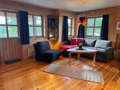 a living room with a couch and a table at Høvringen Lodge in Høvringen