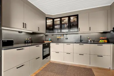 a kitchen with white cabinets and stainless steel appliances at Private Room in a shared Apartment with Mountain Views & Greenery in Trondheim