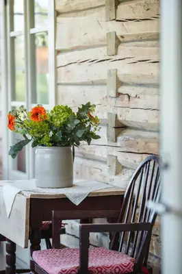 a table with a vase of flowers on it at Steien Hotel in Alvdal