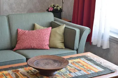 a living room with a couch and a coffee table at Steien Hotel in Alvdal