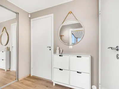 a bathroom with a white cabinet and a mirror at Nice apartment with sea view in Trondheim