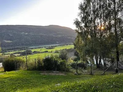 a grassy hill with a view of a valley at Charming family house near Kvitfjell in Ringebu