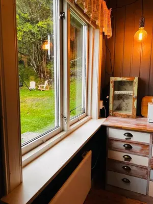 a window in a room with a desk and a picture at Charming family house near Kvitfjell in Ringebu