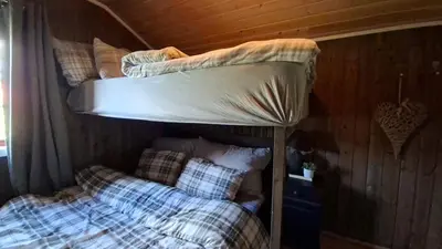 a couple of bunk beds in a room at Trivelig hytte med innlagt strøm og vann Perfekt for familietur Bilveg helt frem in Rotvolden
