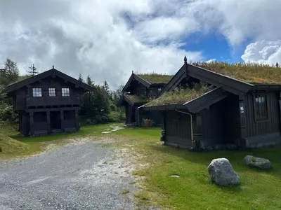 a group of buildings with grass on the roofs at Sleepover in the mountains in Hjartdal
