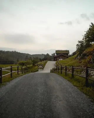 an empty road with a fence on the side at Snerting Ranch Hotel - Comfty and modern Log House in Stokkan
