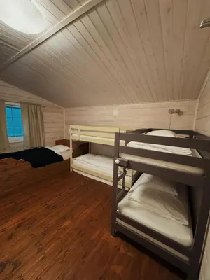a small room with bunk beds in a cabin at Snerting Ranch Hotel - Comfty and modern Log House in Stokkan