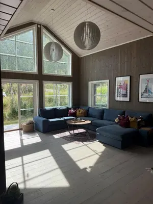 a living room with a blue couch and a table at New cottage near the city center and ski slope in Hemsedal