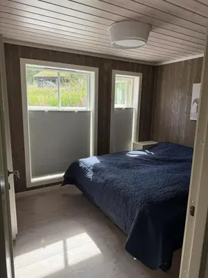 a bedroom with a bed and a window at New cottage near the city center and ski slope in Hemsedal