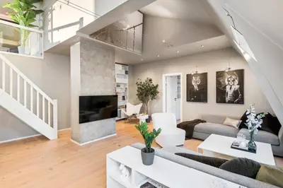 a living room with a couch and a tv at Two bedroom penthouse with large living room and rooftop in the city centre of Trondheim in Trondheim