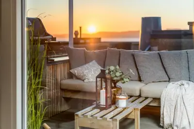 a living room with a couch and a table at Two bedroom penthouse with large living room and rooftop in the city centre of Trondheim in Trondheim