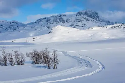 a snow covered mountain with a road in the foreground at Family Friends, 3 Bedroom Apartment With Terrace in Beitostøl