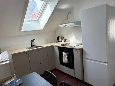 a small kitchen with a sink and a stove at In the middle of Bergen City in a real Bergenshus from the 18th Century in Bergen