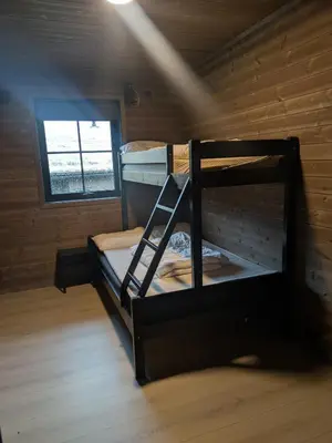 a room with two bunk beds and a window at 2 Cabins surrounded by beautiful nature in Stryn