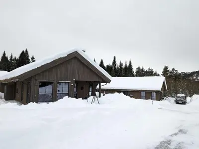 a house with snow on the roof of it at 2 Cabins surrounded by beautiful nature in Stryn