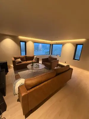 a large living room with couches and a table at Modern detached house with a view in Arefjord