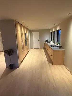 a large kitchen with a sink and a counter at Modern detached house with a view in Arefjord