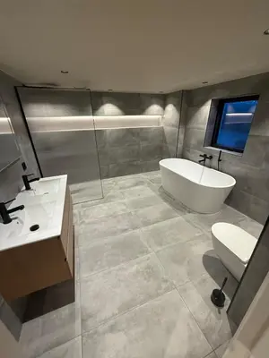 a bathroom with a tub and a toilet and a sink at Modern detached house with a view in Arefjord