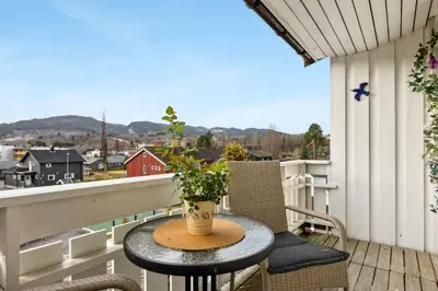 a table and chairs on a balcony with a view at Spacious 3-Bedroom Apartment with Balcony and Free Parking Orkland near Trondheim in Fannrem