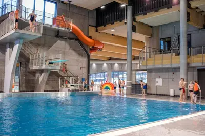 a large swimming pool with people standing around it at Spacious 3-Bedroom Apartment with Balcony and Free Parking Orkland near Trondheim in Fannrem