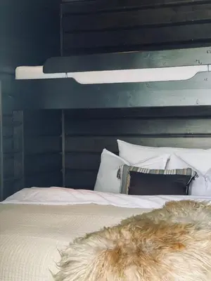 a white bed with a furry blanket on top of it at No71 Golsfjellet in Golsfjellet