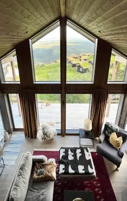 a living room with a large window and a couch at Stylish Cabin With Lovely View At Stavadalen in Reinli