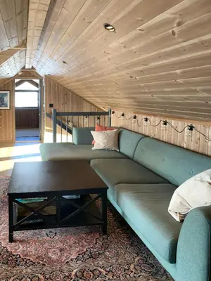 a living room with a couch and a coffee table at Stylish Cabin With Lovely View At Stavadalen in Reinli