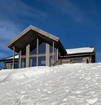 a house on top of a pile of snow at Stylish Cabin With Lovely View At Stavadalen in Reinli