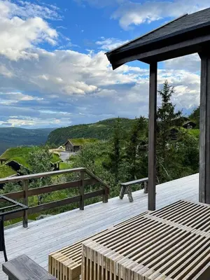 a wooden deck with a bench and a view at Stylish Cabin With Lovely View At Stavadalen in Reinli