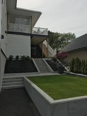 a house with stairs and a yard with grass at Casa Oyen in Ålesund