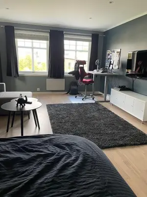 a living room with a couch and a chair and a desk at Casa Oyen in Ålesund