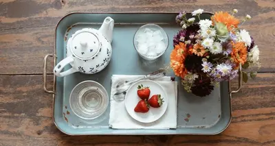 a tray with a plate of strawberries and flowers at Waterfall Retreat in Sel