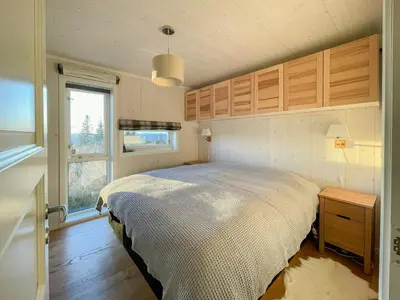 a bedroom with a bed in a room with a window at Cabin With Panoramic Views In Hafjell in Øyer