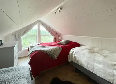 a attic bedroom with a bed and a window at Cabin With Panoramic Views In Hafjell in Øyer