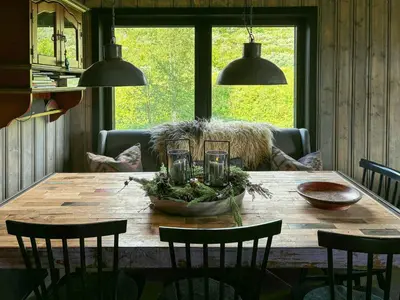 a wooden table with chairs and a bowl on it at Spacious Apartment By Hardangervidda National Park in Ustaoset