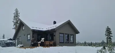 a small house with snow on the roof at New Cabin With Panoramic Views Of Lake Osen