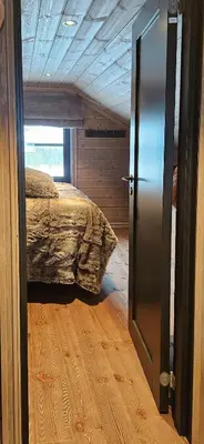 an open door to a bedroom with a bed at New Cabin With Panoramic Views Of Lake Osen