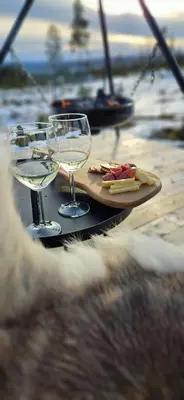 a table with two glasses of wine and food on it at New Cabin With Panoramic Views Of Lake Osen