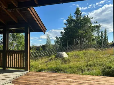 a porch of a cabin with a view of a field at Family Cabin With Charm in Mesnali