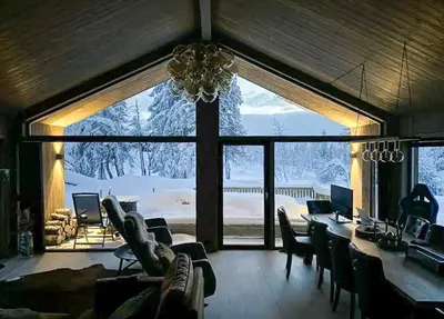 a living room with a dining table and a large window at Modern Cabin Close To The Ski Slopes In Haglebu in Eggedal