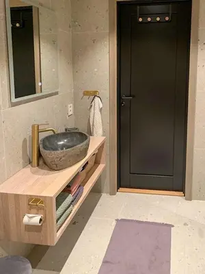 a bathroom with a sink and a black door at Modern Cabin Close To The Ski Slopes In Haglebu in Eggedal