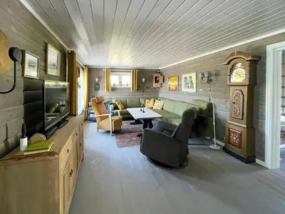a living room with a couch and a table and a tv at Family Cabin In Rauland in Rauland