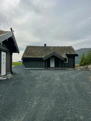 a house with a driveway in front of a garage at Family Cabin In Rauland in Rauland