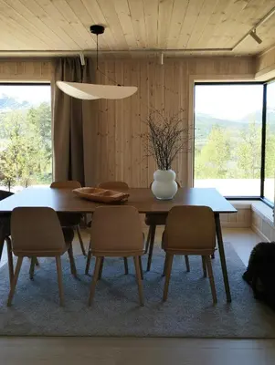 a dining room with a table and chairs at Mountain Cabin With View At Bjorli in Bjorli