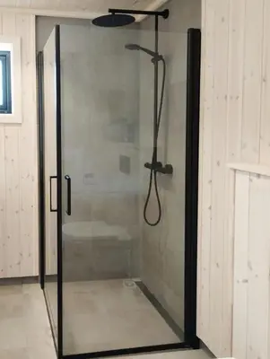 a shower with a glass door in a bathroom at Mountain Cabin With View At Bjorli in Bjorli
