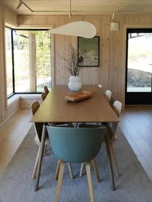 a dining room with a wooden table and chairs at Mountain Cabin With View At Bjorli in Bjorli
