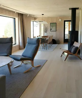 a living room with a couch and chairs and a table at Mountain Cabin With View At Bjorli in Bjorli