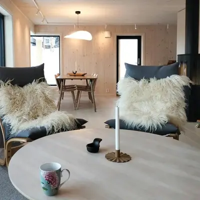 a living room with couches and a table with a candle at Mountain Cabin With View At Bjorli in Bjorli