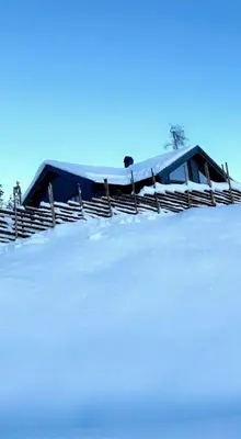 a snow covered roof of a house with a fence at Cabin With Views Over Hafjell And Gausdal in Svingvoll